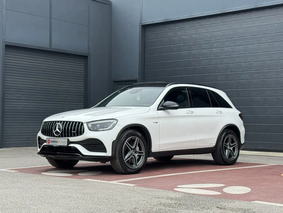 Bijeli Mercedes-Benz GLC 43 AMG, prednji lijevi bočni pogled ispred sive hale